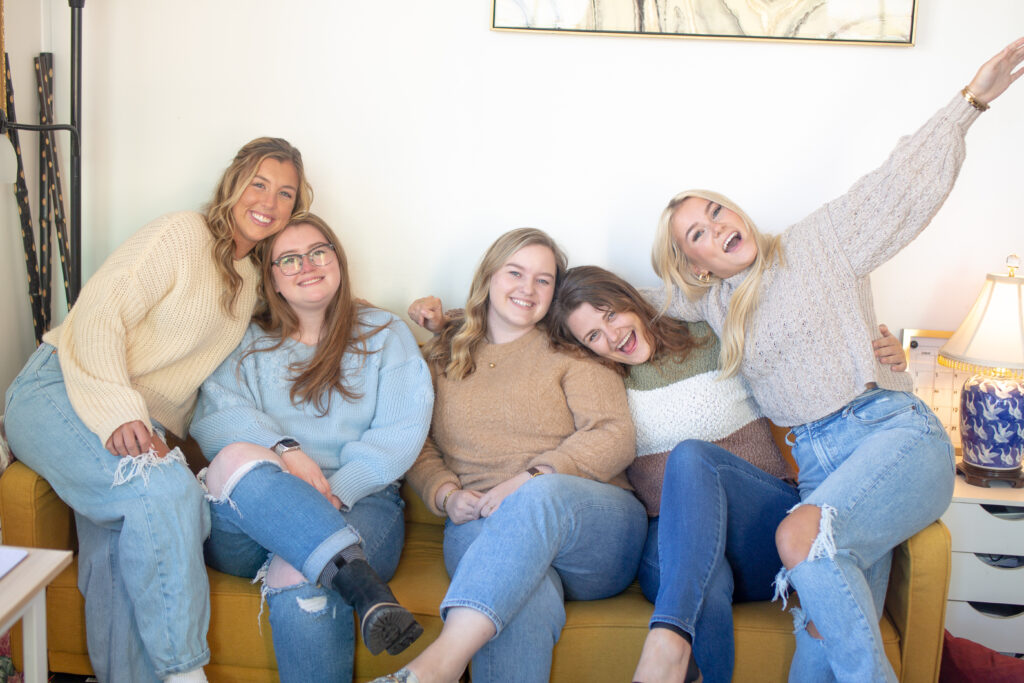 Five women sitting on a couch, hugging and smiling at the camera. Previous SSM Creative Collective team. I F-ed Up new blog from SSM Business Collective